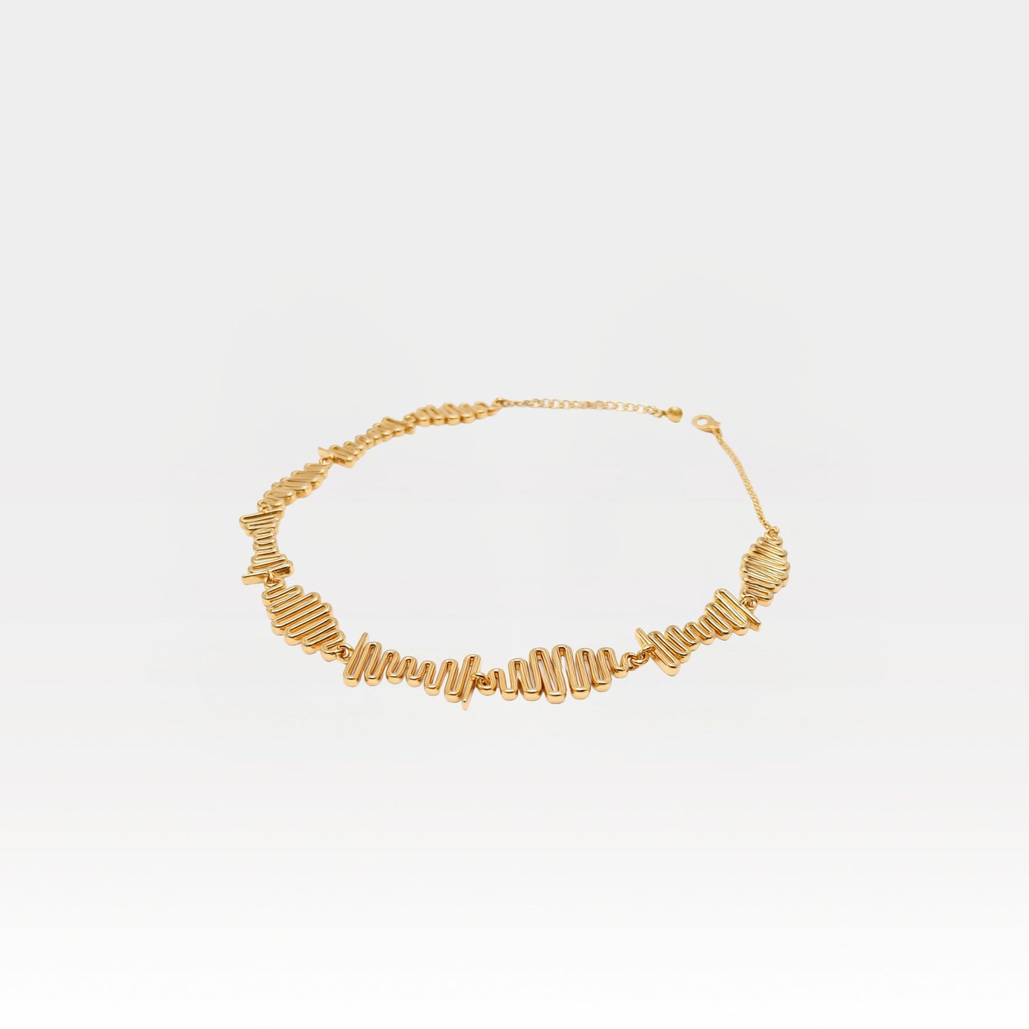 Gold necklace on a light gray background