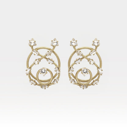 Gold earrings with intricate design and clear stones on a light gray background