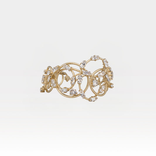 Gold bracelet with crystals on a light gray background