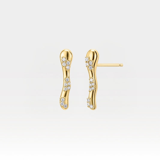 A pair of gold wavy bar stud earrings adorned with small clusters of clear pavé-set stones, shown against a clean white background.
