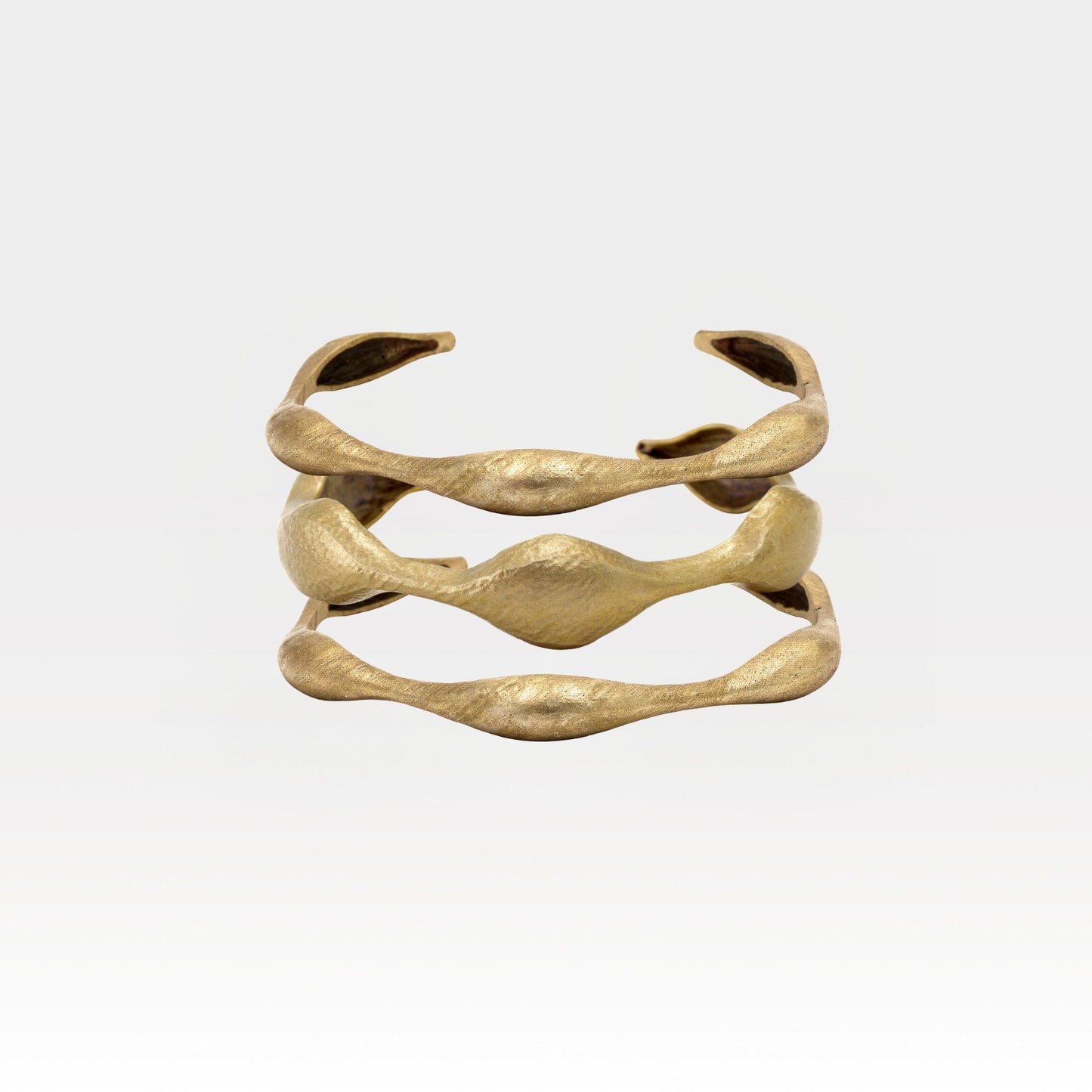 Gold bracelet on a light gray background