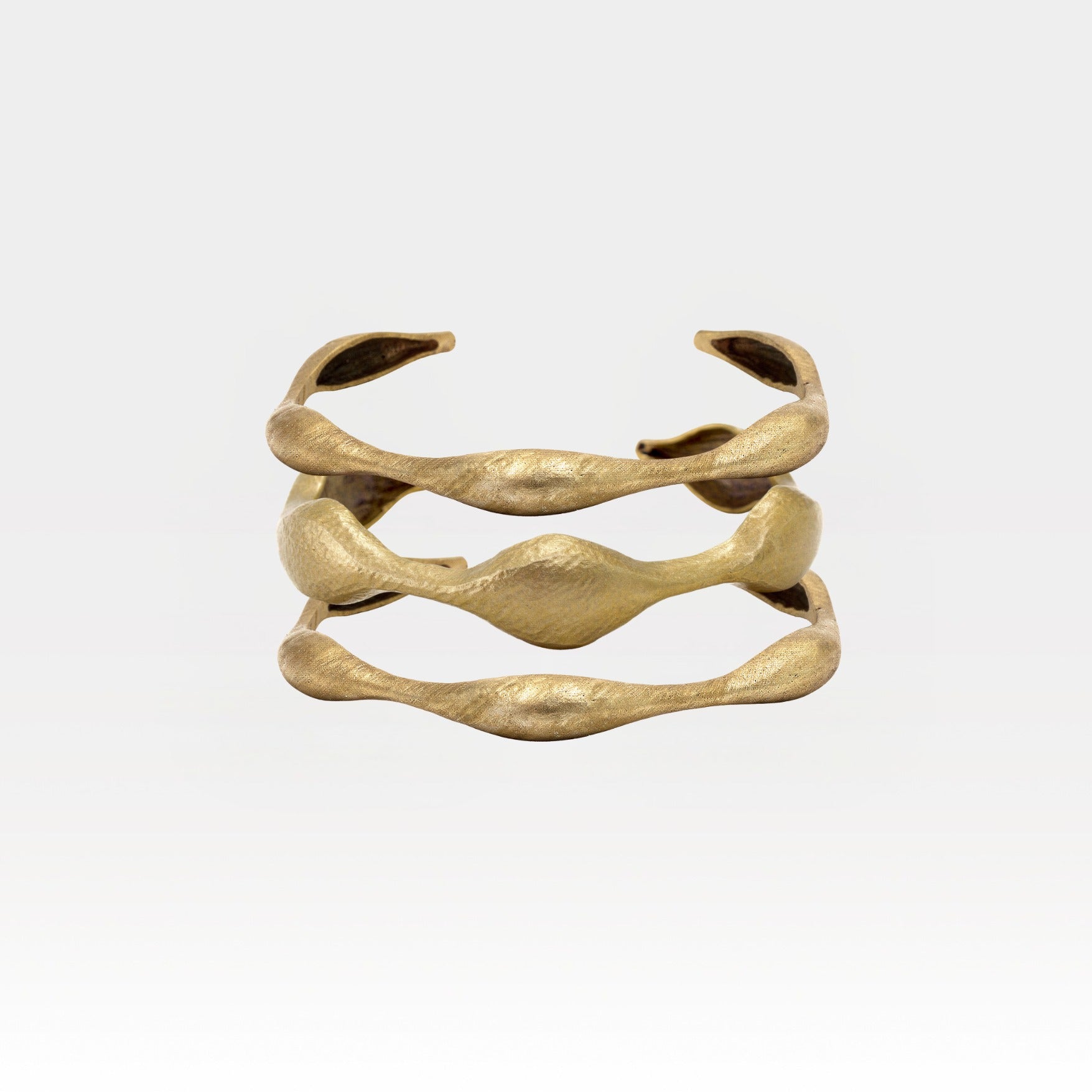 Gold bracelet on a light gray background