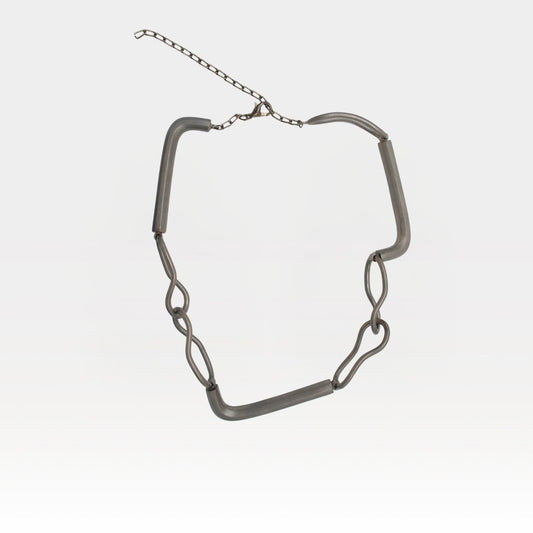 Silver chain necklace on a light gray background