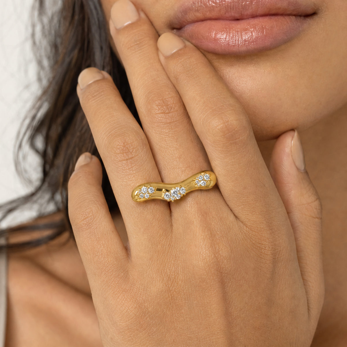 close up of a woman wearing gold ring with CZ