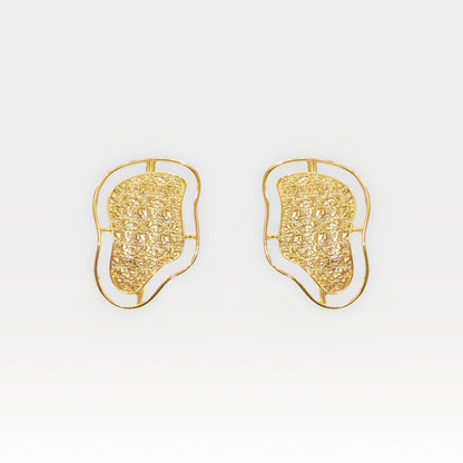 Pair of sculptural gold contour stud earrings with textured surface and fluid outline.