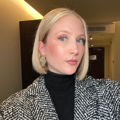 Close-up of a model wearing abstract gold contour earrings from the Contour Collection.