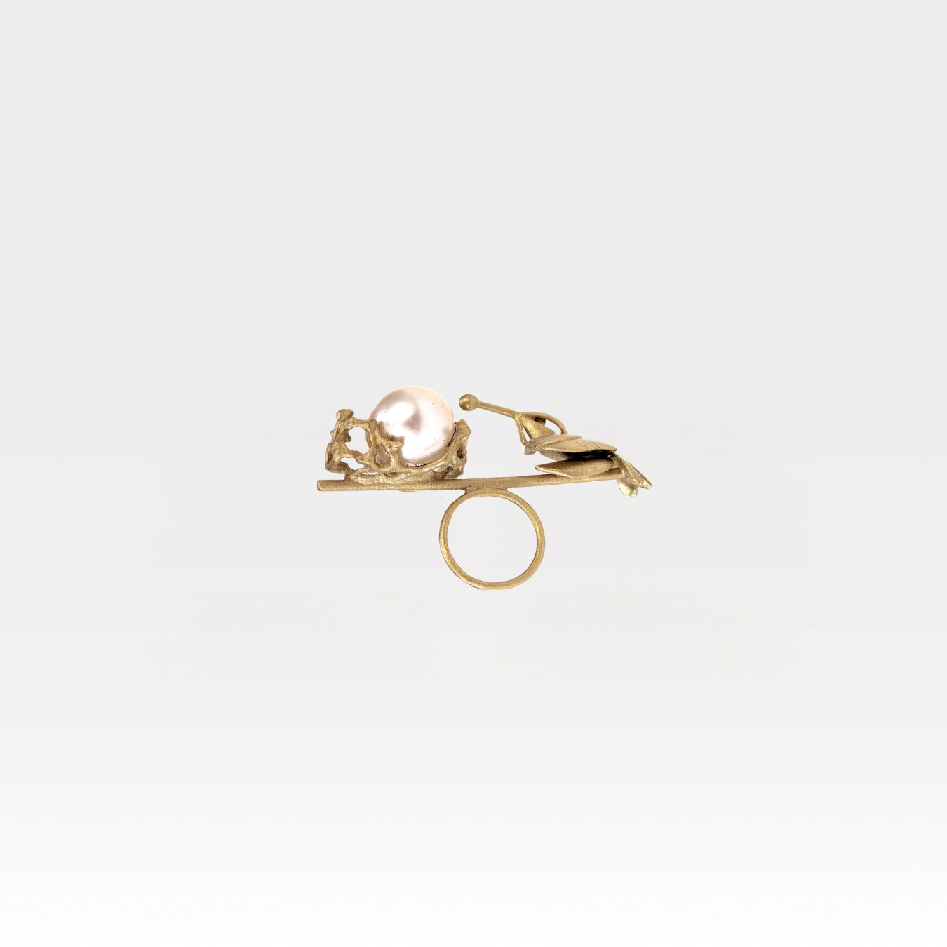Gold ring with a pearl on a white background