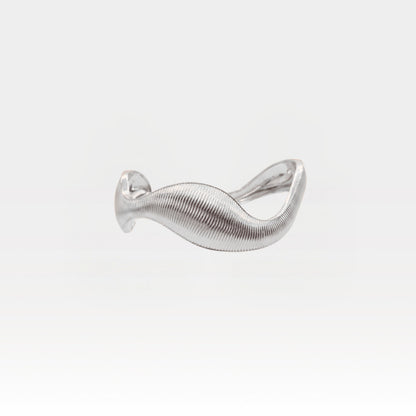 Silver bracelet with a wavy design on a light gray background