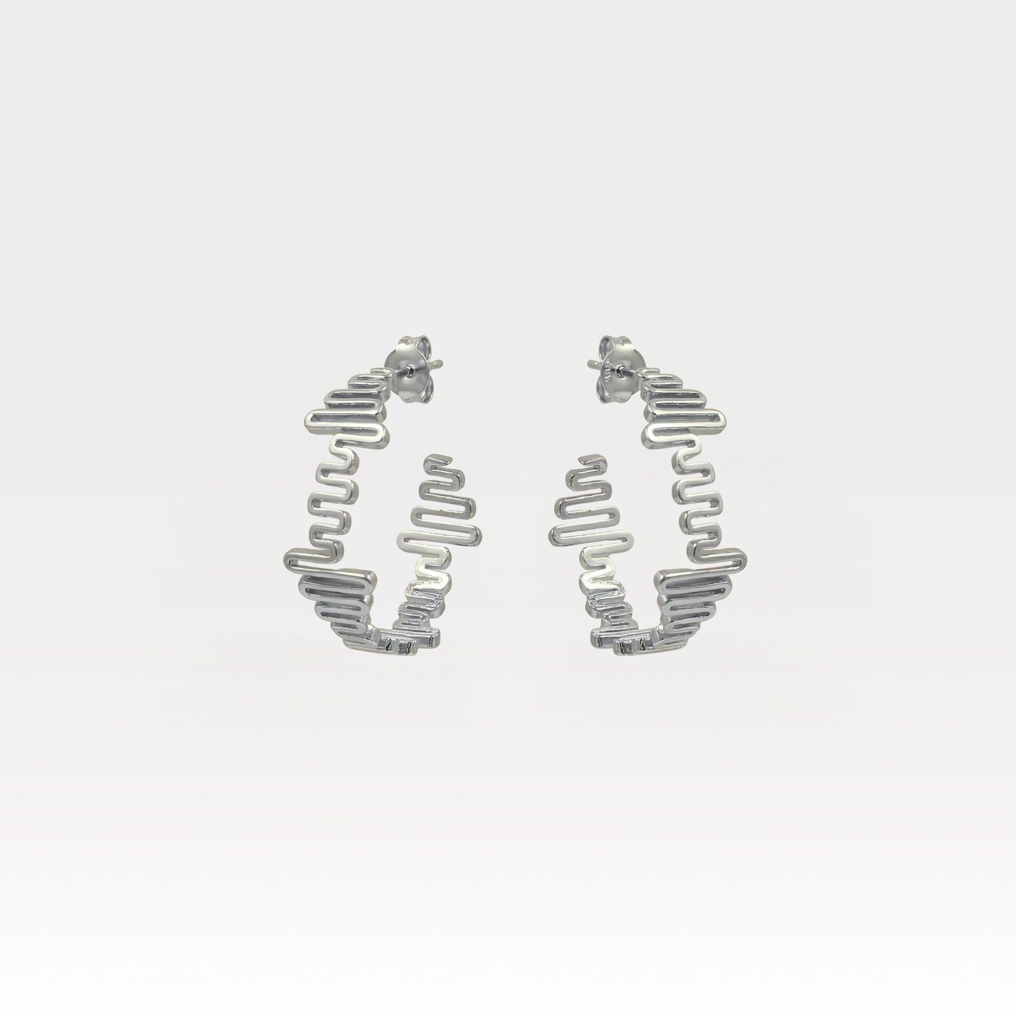 Silver hoop earrings on a light gray background