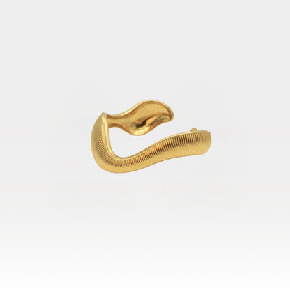 Sculptural 18k gold plated cuff bracelet with a wavy textured design on a light background