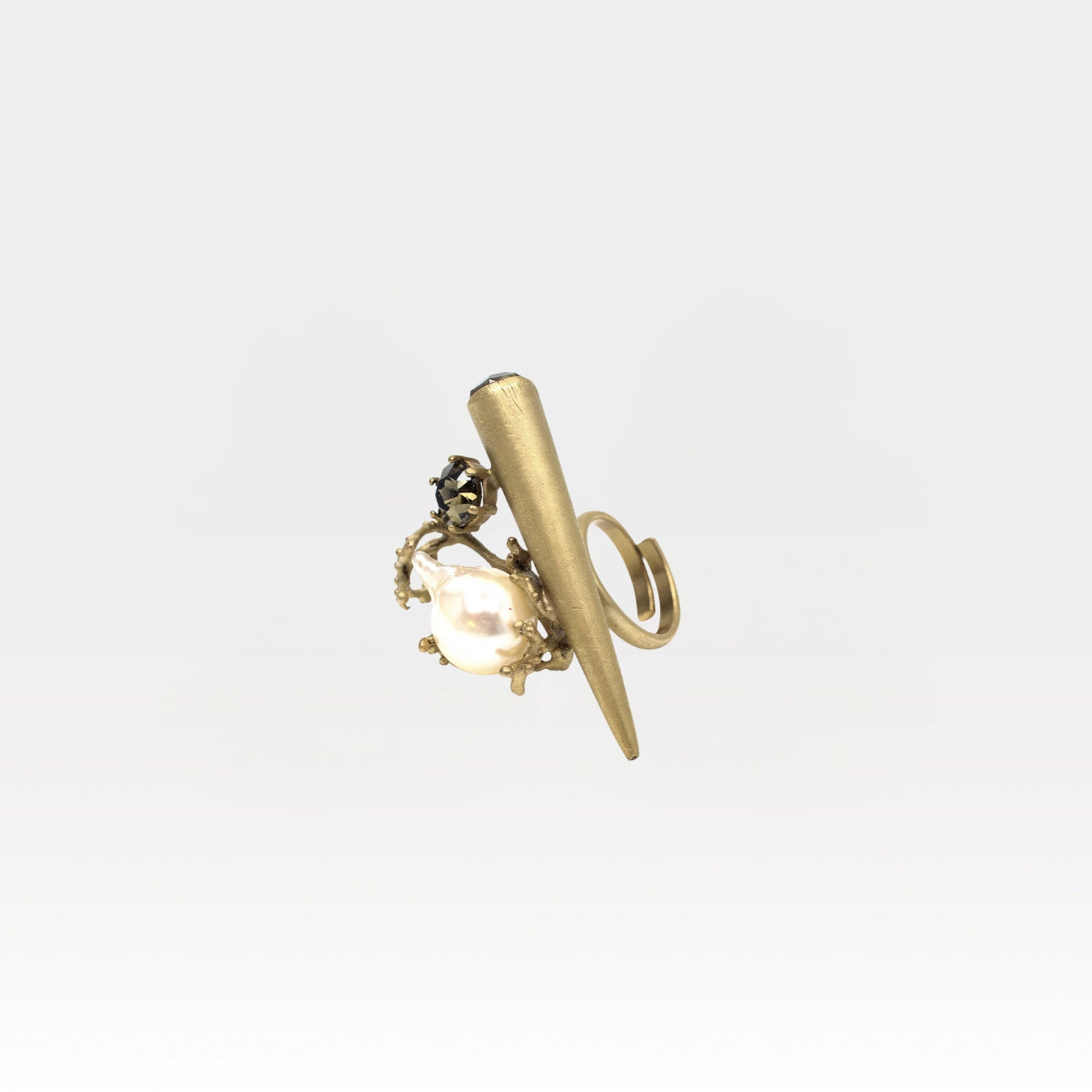Gold ring with a clear gemstone on a white background
