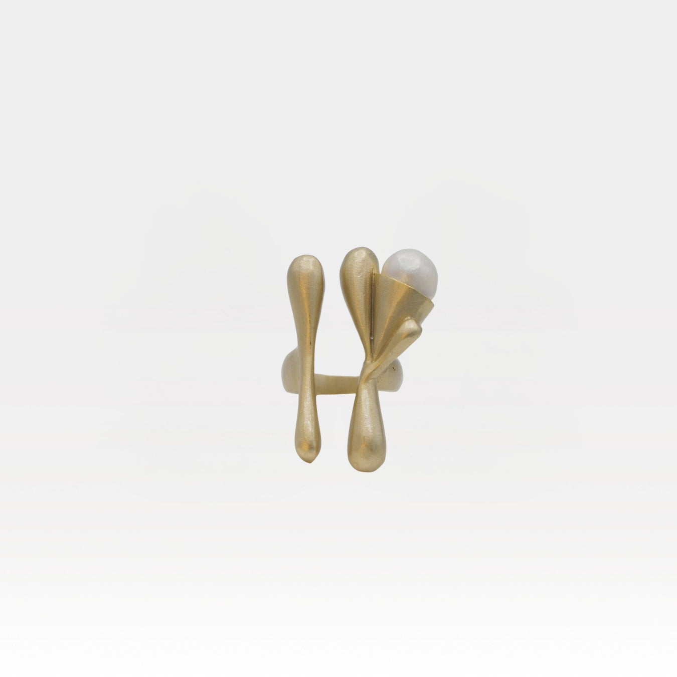 Gold ring with a pearl on a white background