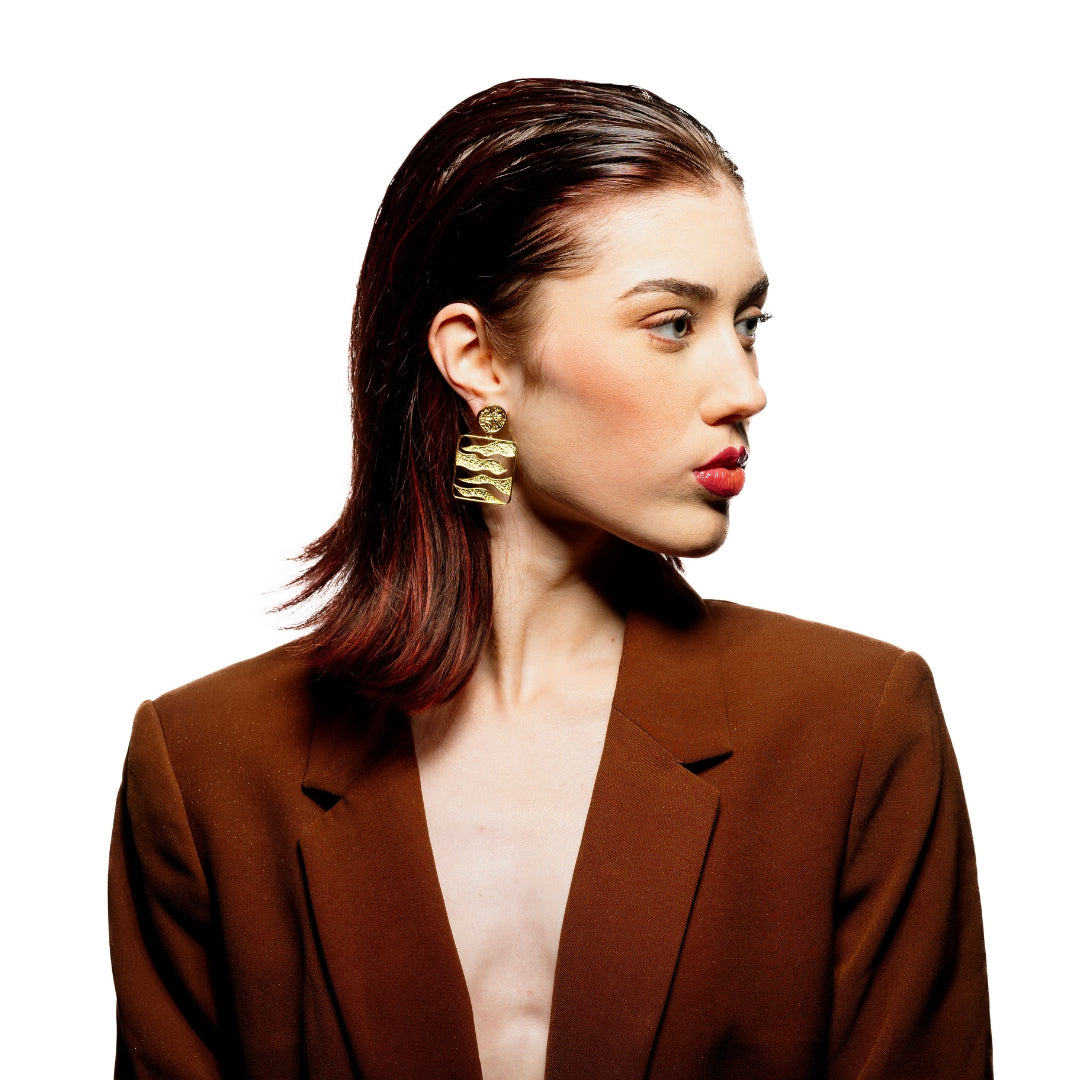 Model wearing handcrafted statement earrings with 18K gold plating