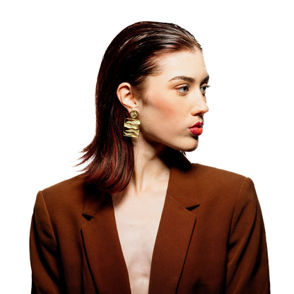 Model wearing handcrafted statement earrings with 18K gold plating