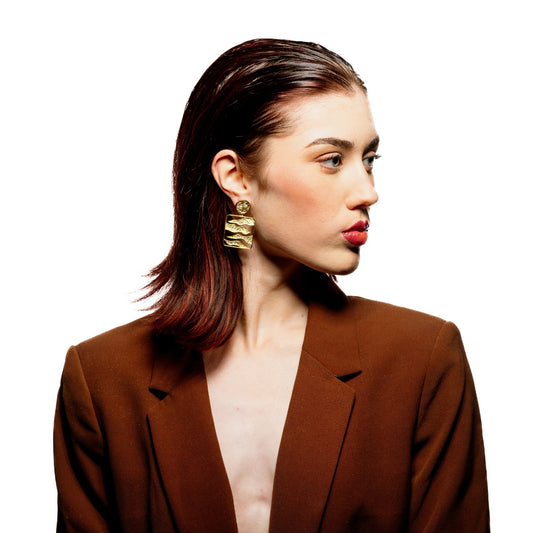 Model wearing handcrafted statement earrings with 18K gold plating