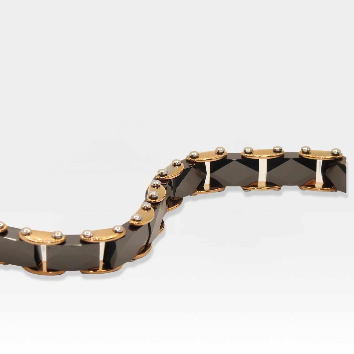 Rose gold and faceted black ceramic link bracelet with a luxurious design.