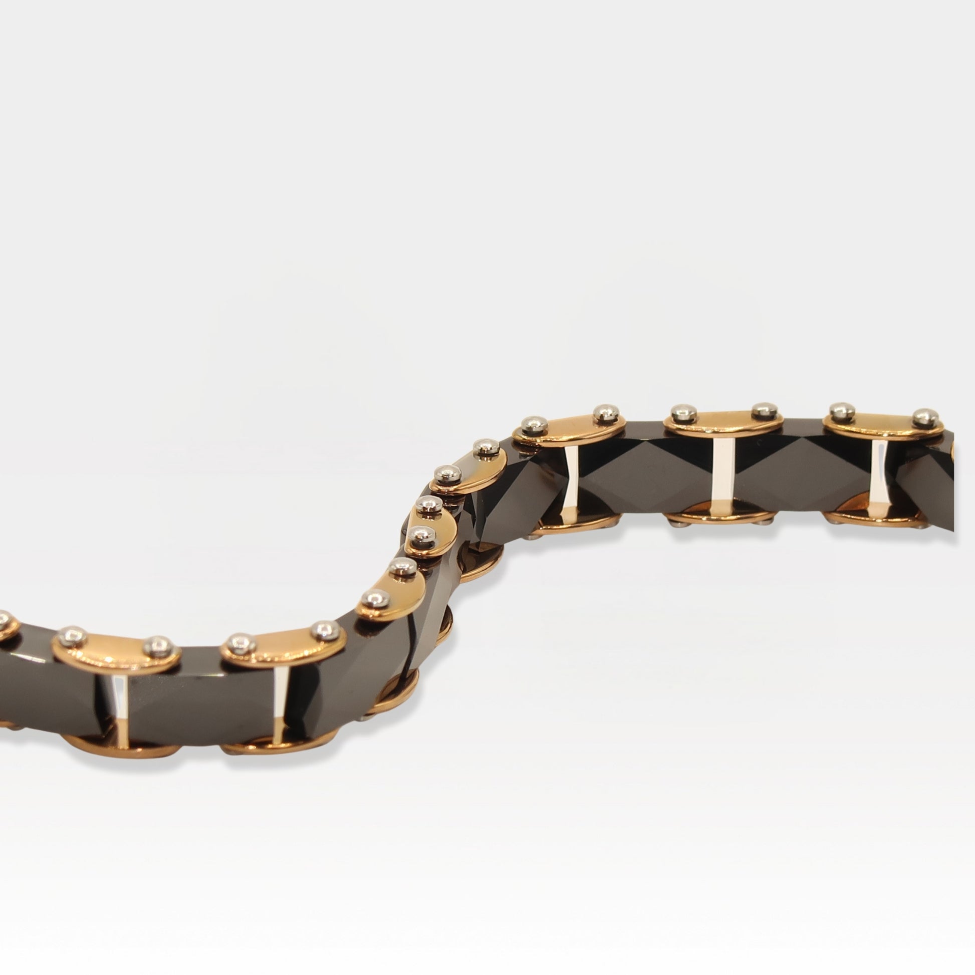 Rose gold and faceted black ceramic link bracelet with a luxurious design.