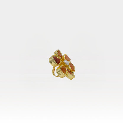 Gold-colored flower-shaped ring on a white background