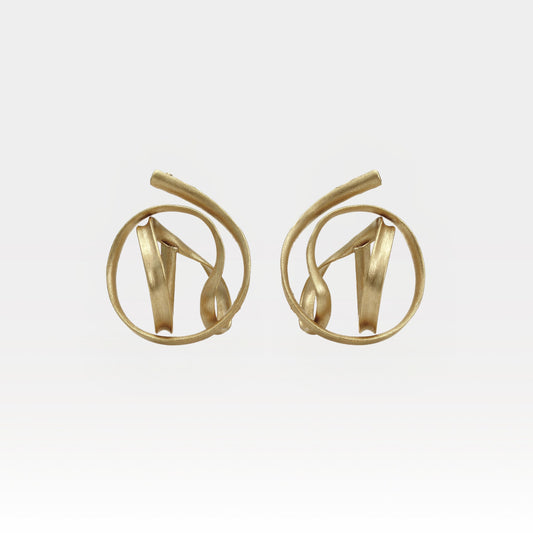 Pair of gold earrings on a light gray background